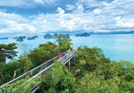 Tourists walking on the metal skywalk at Hong Island 360 degree viewpoint in Krabi Thailand