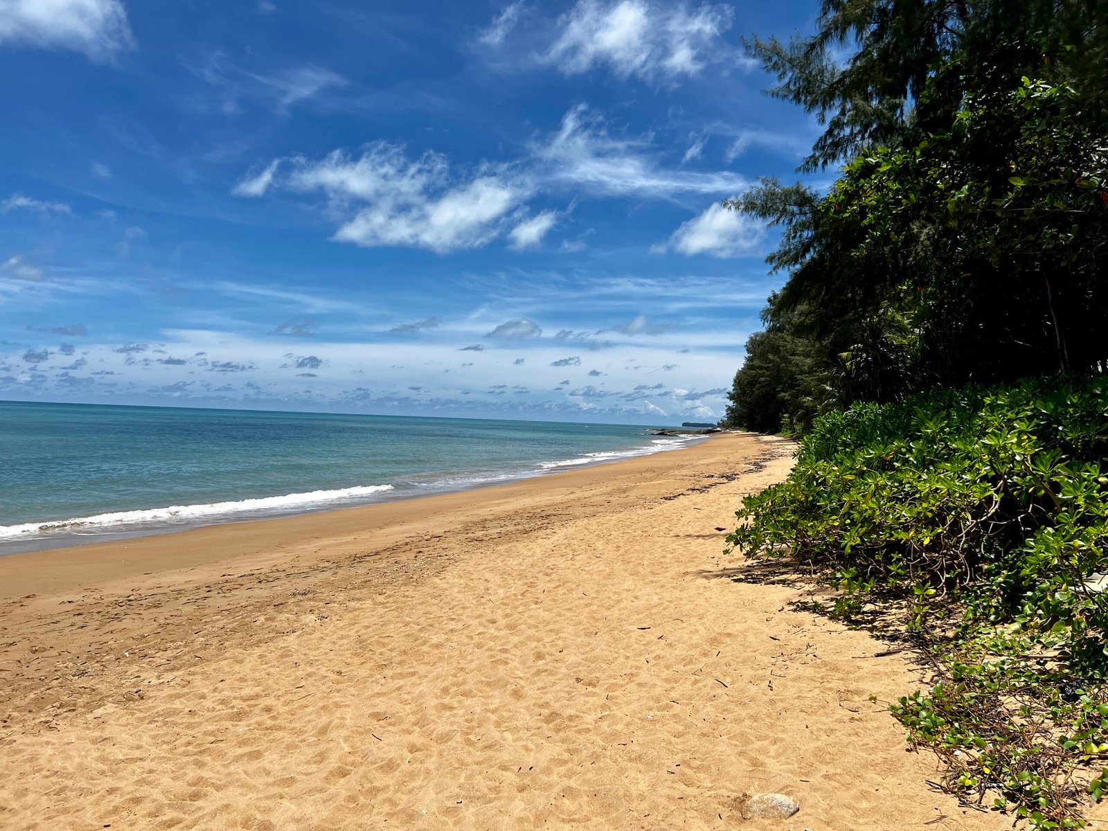 Phuket vs Khao Lak beaches comparison featuring Karon Beach in Phuket and Nang Thong Beach in Khao Lak, Thailand