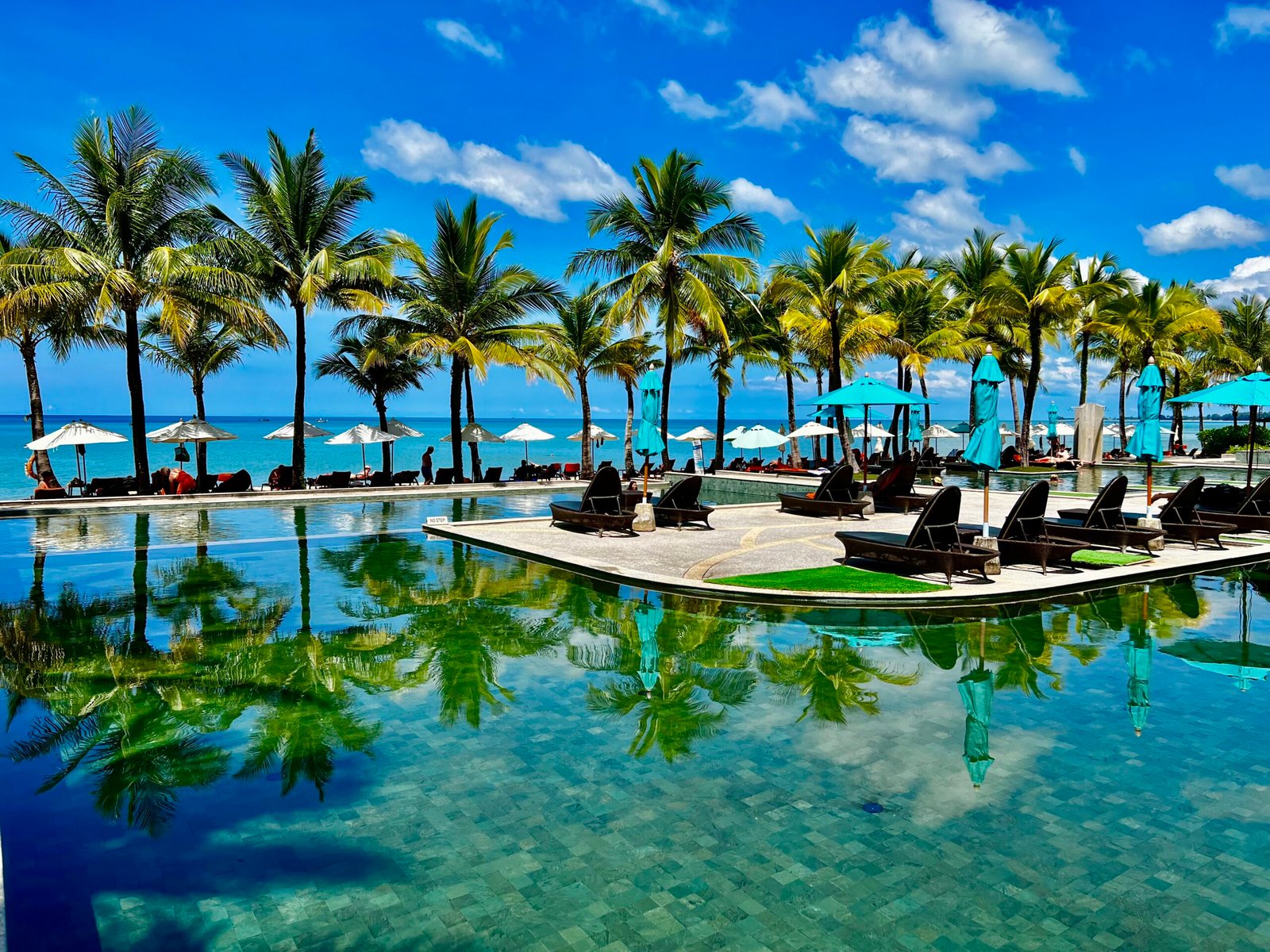 Phuket vs Khao Lak beaches comparison featuring Karon Beach in Phuket and Nang Thong Beach in Khao Lak, Thailand