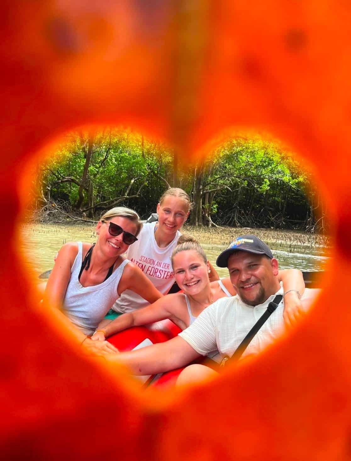 Leaf cut heart shape paddle boy smiling guests canoe Phang Nga Bay
