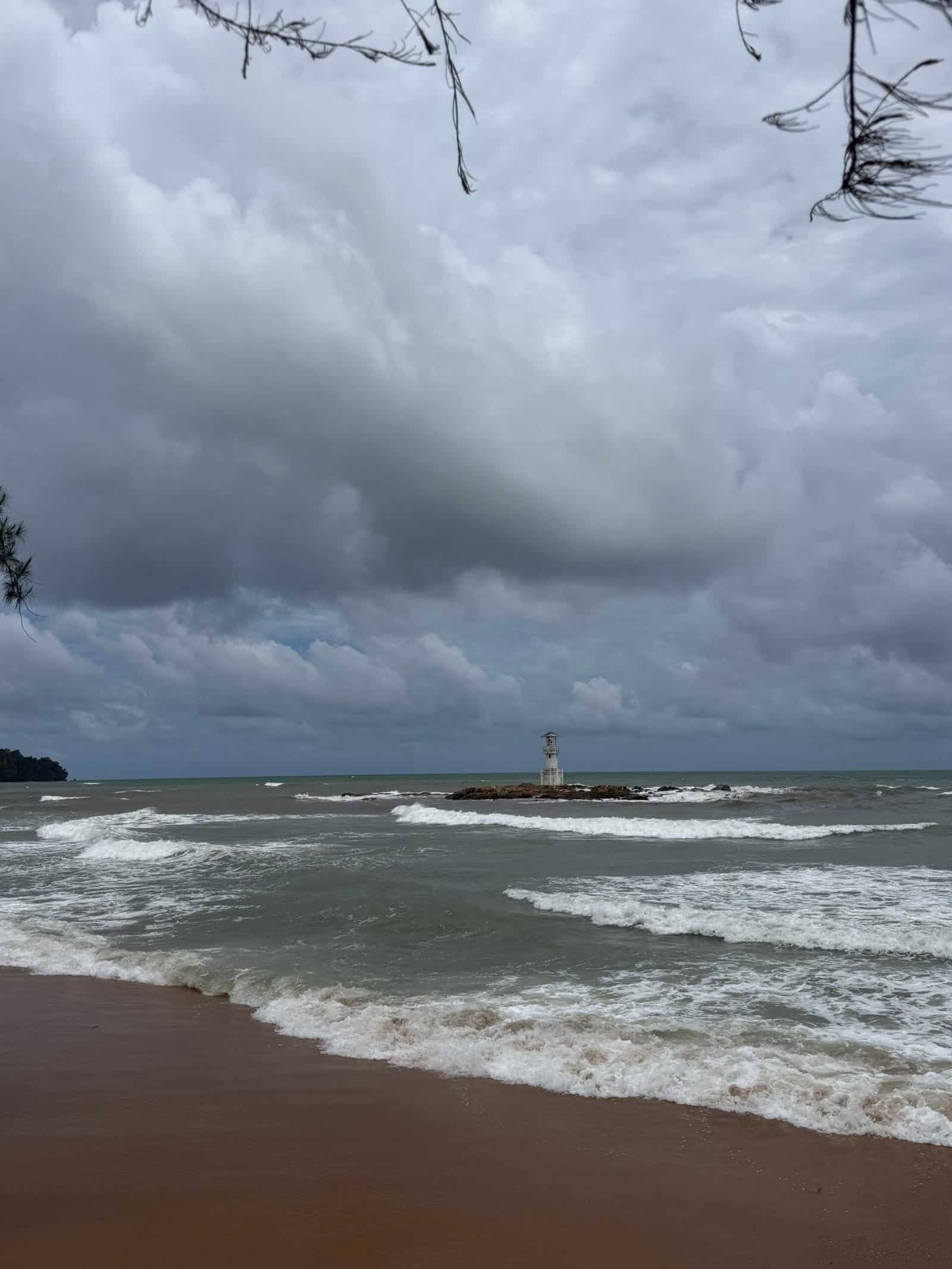 Nangthong Beach Khao Lak rainy season rough sea lighthouse dark clouds