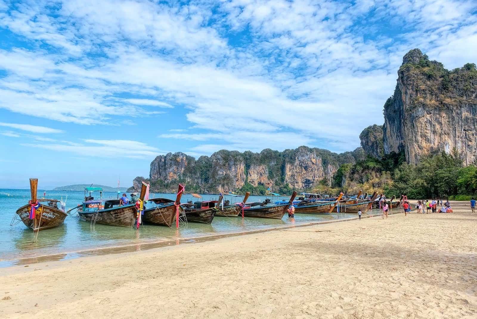 Railay Beach West in Krabi with limestone cliffs and traditional longtail boats, Thailand