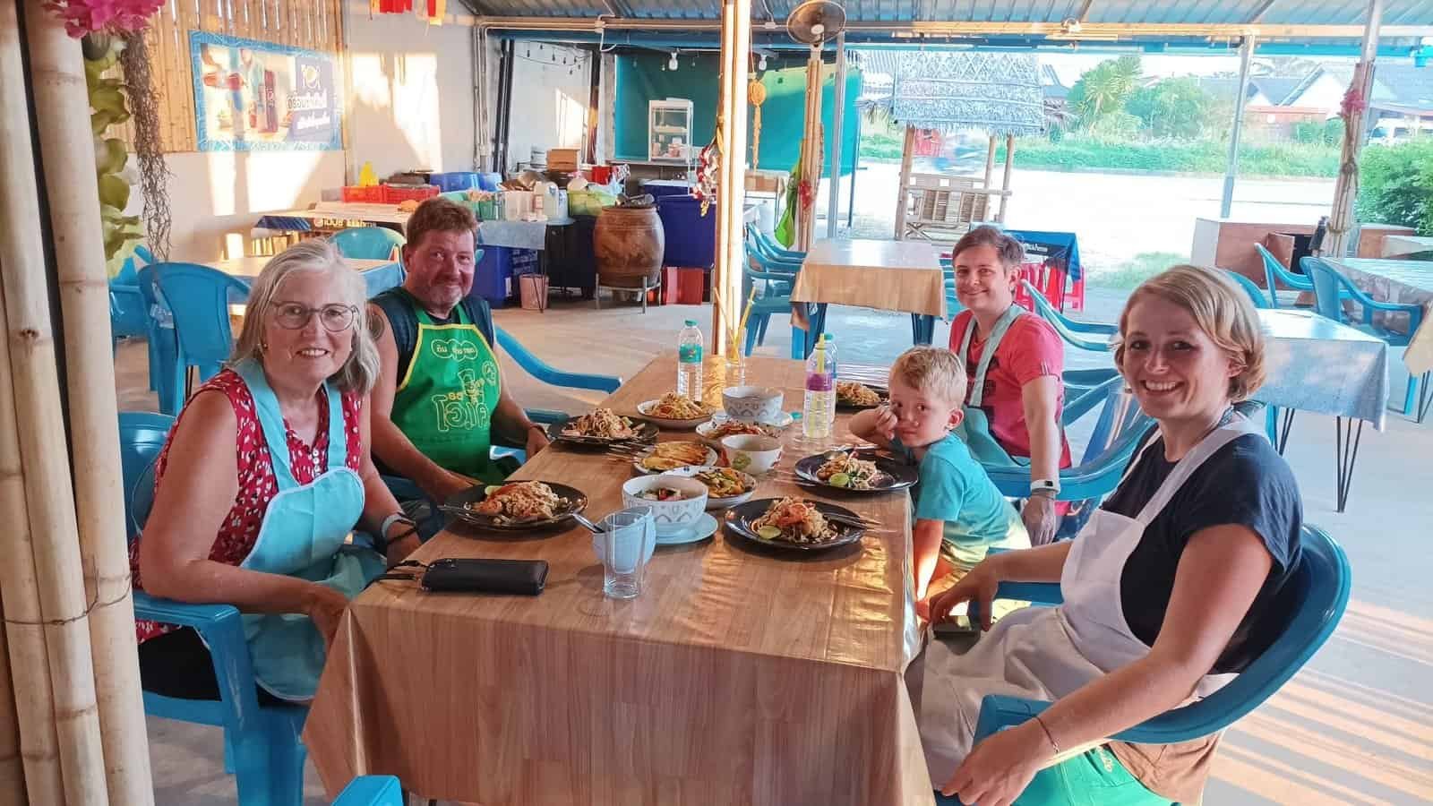 Guests enjoying a shared dinner of their own home-cooked Thai dishes in Khao Lak